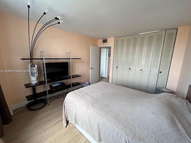 bedroom featuring light hardwood / wood-style flooring and a closet