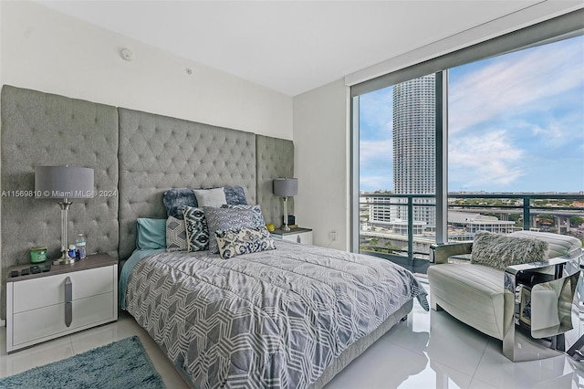 bedroom with floor to ceiling windows and light tile patterned flooring