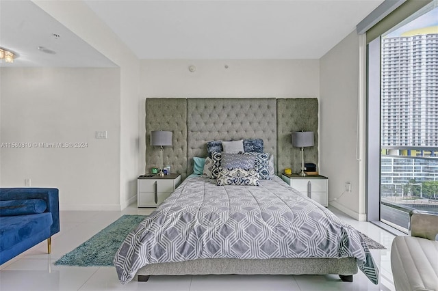 tiled bedroom featuring floor to ceiling windows and multiple windows