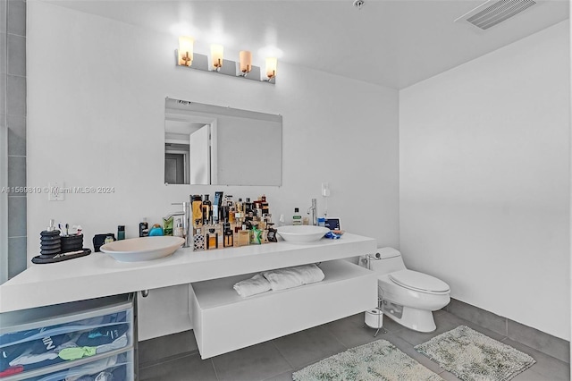 bathroom with tile patterned floors, toilet, and sink