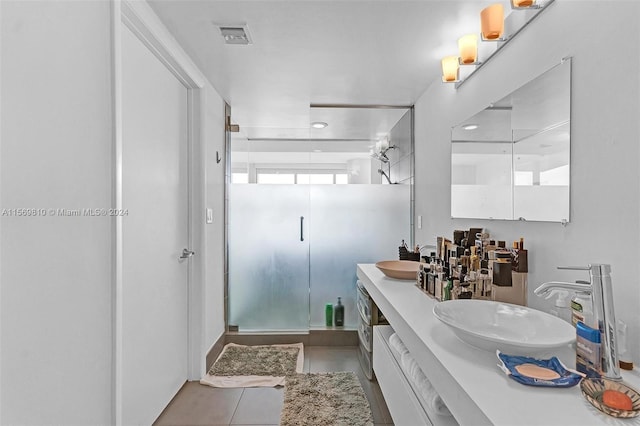 bathroom featuring vanity, tile patterned floors, and an enclosed shower