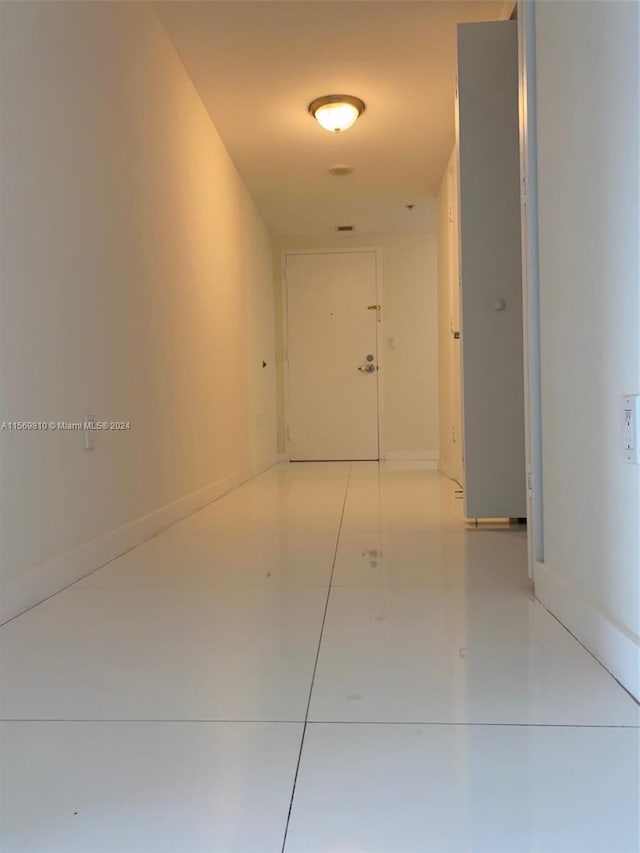 corridor with light tile patterned floors