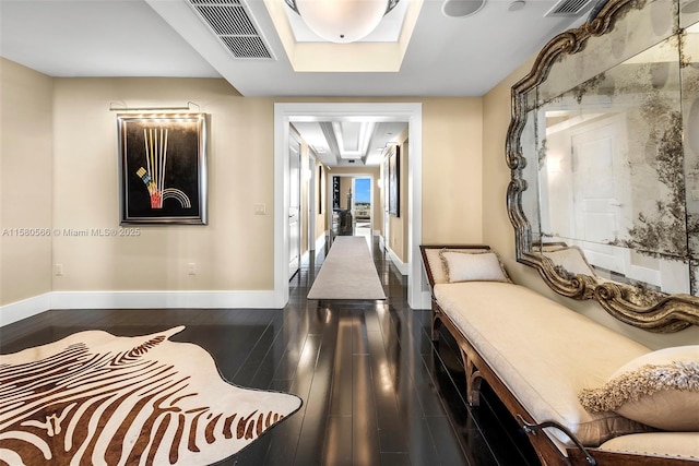 hallway featuring baseboards, visible vents, and dark wood-style flooring