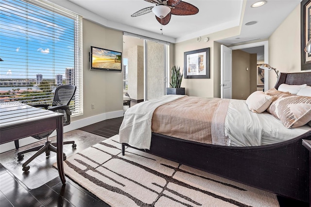 bedroom featuring dark wood-type flooring, baseboards, and a ceiling fan