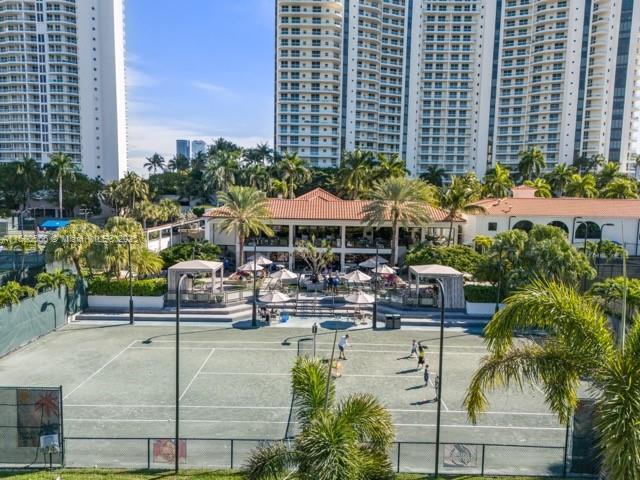 view of tennis court with a city view