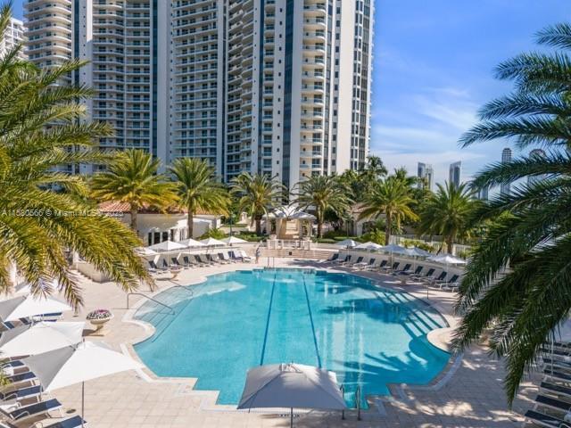 pool with a city view and a patio