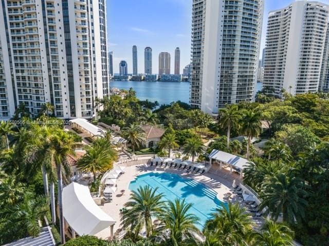 pool with a water view, a city view, and a patio