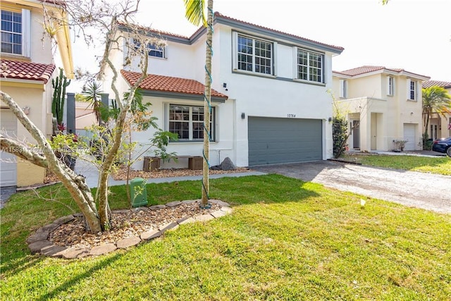 mediterranean / spanish home with a garage and a front yard