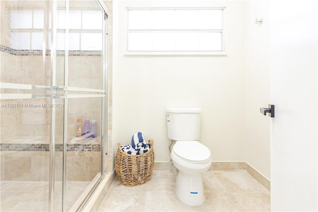 bathroom with a shower with door, tile floors, a healthy amount of sunlight, and toilet