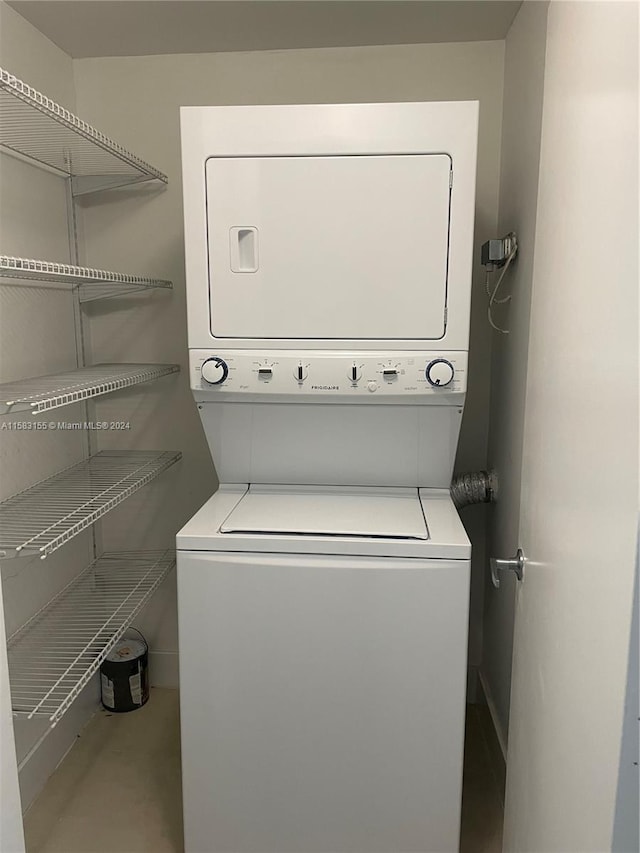 laundry area featuring stacked washer / drying machine