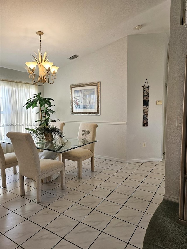 tiled dining room with lofted ceiling and an inviting chandelier