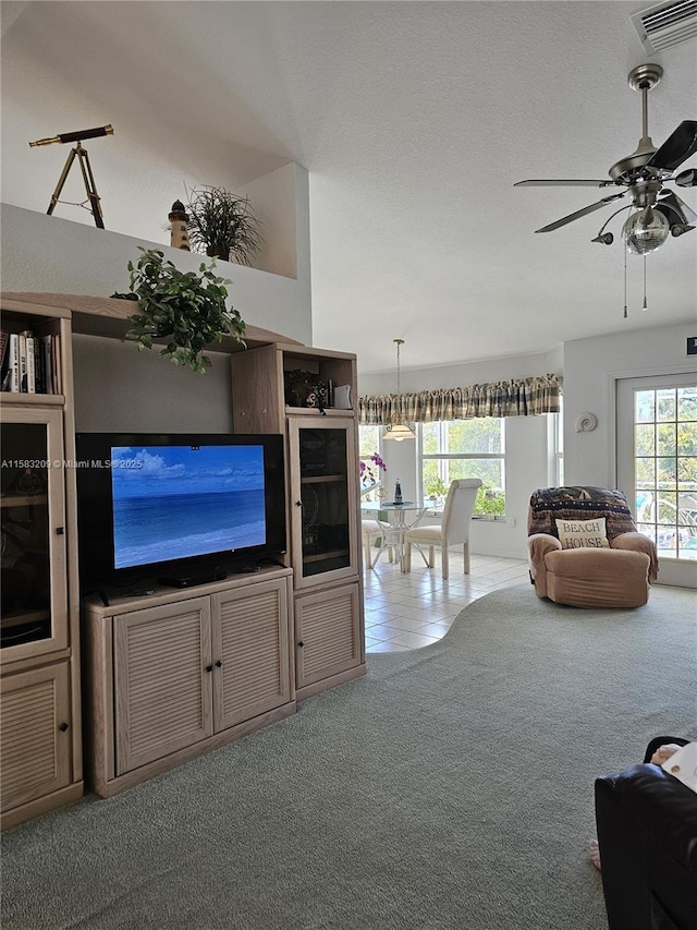 unfurnished living room featuring ceiling fan and carpet