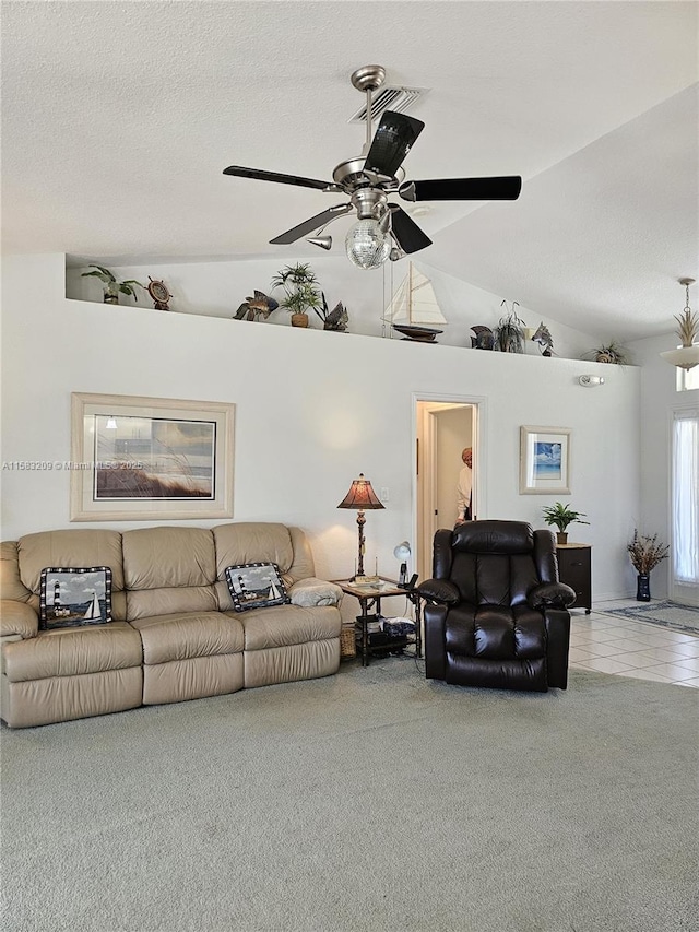 carpeted living room featuring ceiling fan, lofted ceiling, and a textured ceiling