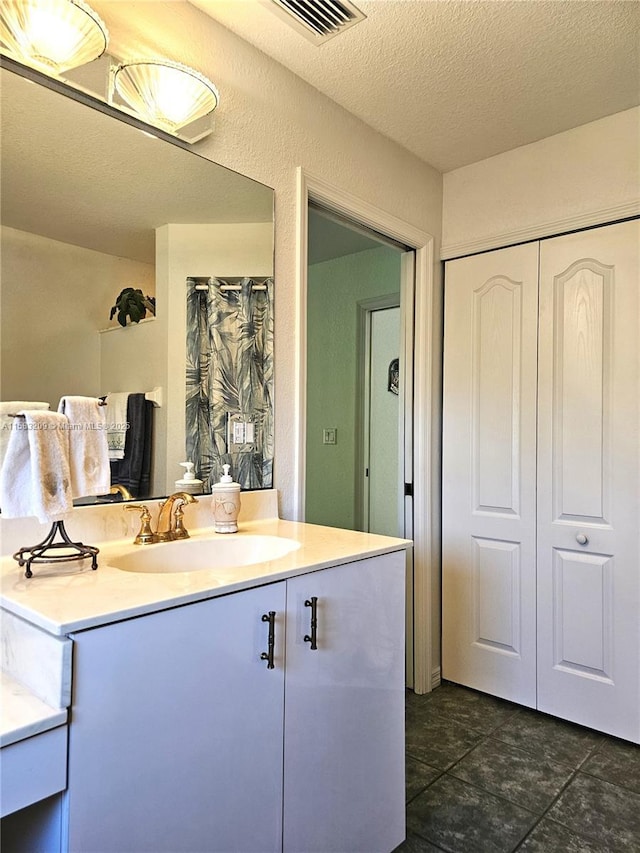 bathroom with vanity and a textured ceiling