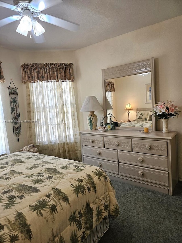 bedroom featuring ceiling fan and carpet