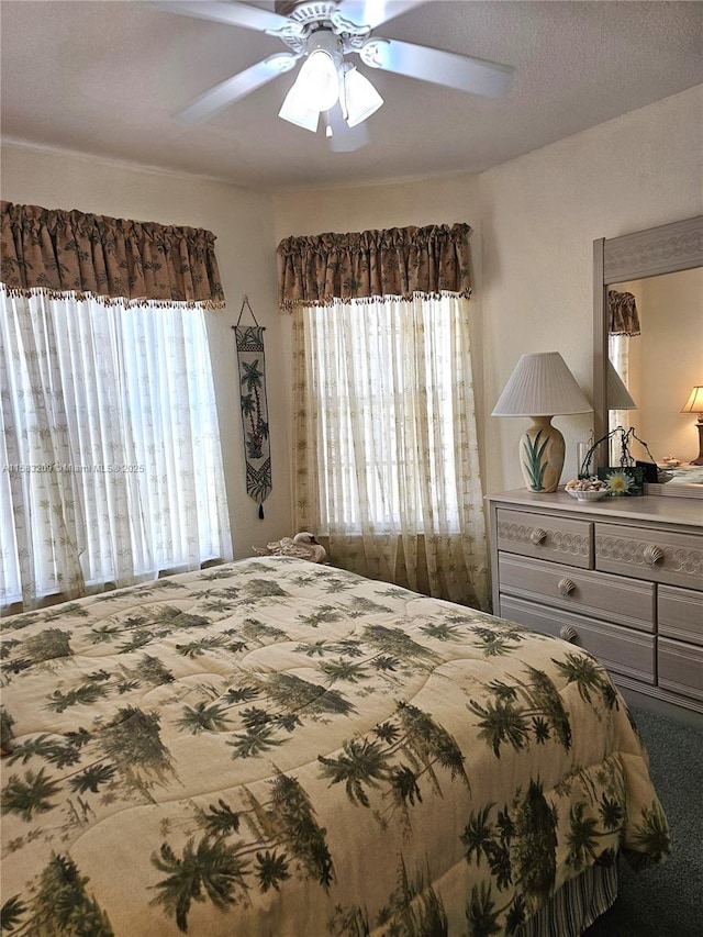 bedroom with ceiling fan and carpet flooring