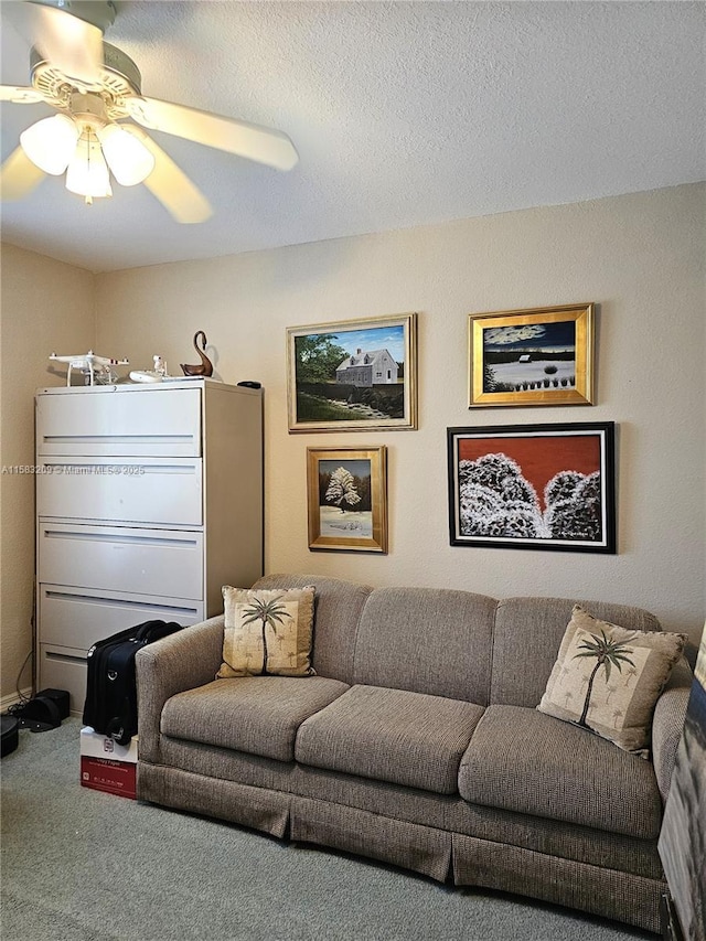 living room featuring carpet flooring, a textured ceiling, and ceiling fan