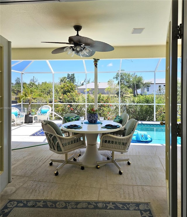 sunroom / solarium featuring ceiling fan