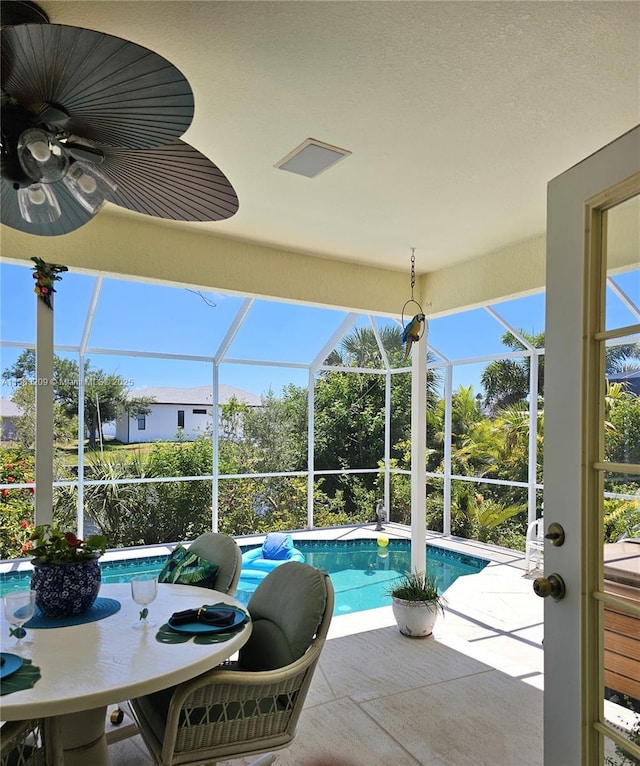 view of pool with a patio, a lanai, and ceiling fan