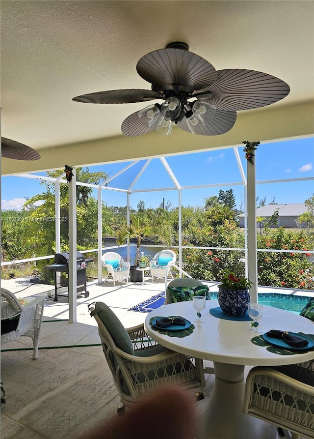 view of patio / terrace featuring a grill and a lanai