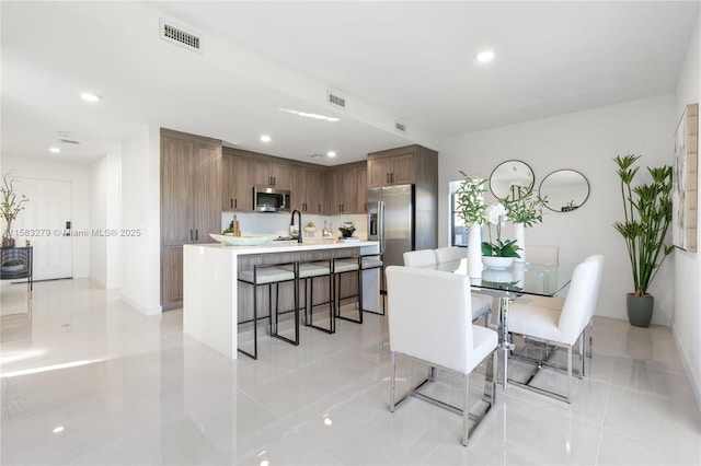 dining room with recessed lighting and visible vents