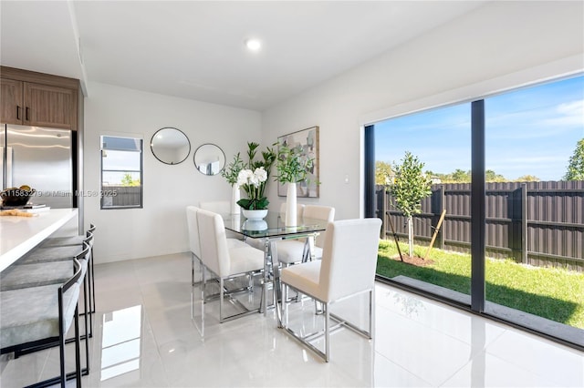 dining room with light tile patterned floors and baseboards