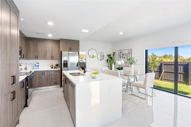 kitchen with a sink, stainless steel appliances, recessed lighting, and light countertops