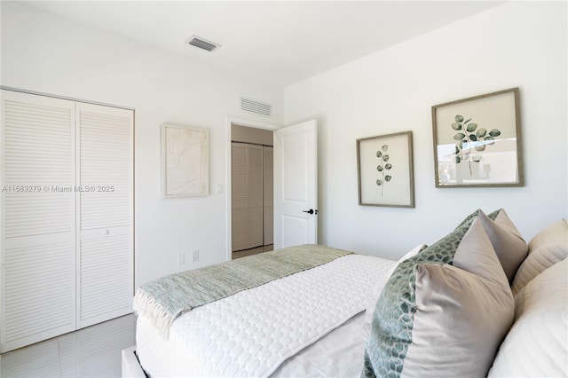 bedroom featuring visible vents and a closet