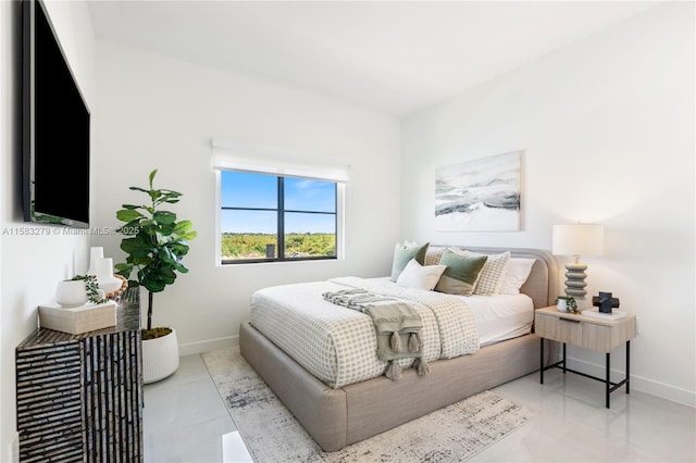 tiled bedroom featuring baseboards