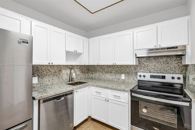 kitchen with decorative backsplash, sink, stainless steel appliances, white cabinets, and light stone counters