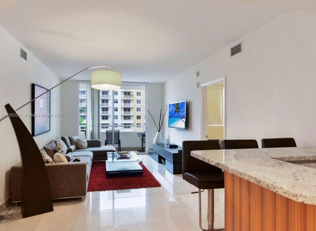 18800 NE 29th Ave Unit 520, Aventura, FL 33180 - living room with a wall of windows and light tile patterned floors