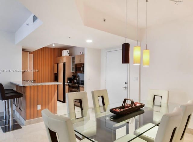 dining space featuring light tile floors