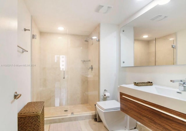 bathroom featuring vanity, tile floors, and a shower with shower door