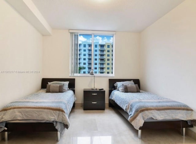 bedroom featuring light tile floors