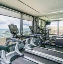 exercise room with a water view