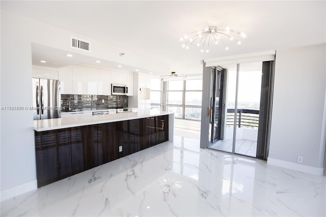 kitchen with expansive windows, white cabinetry, stainless steel appliances, sink, and light tile floors