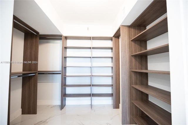 spacious closet featuring light tile flooring