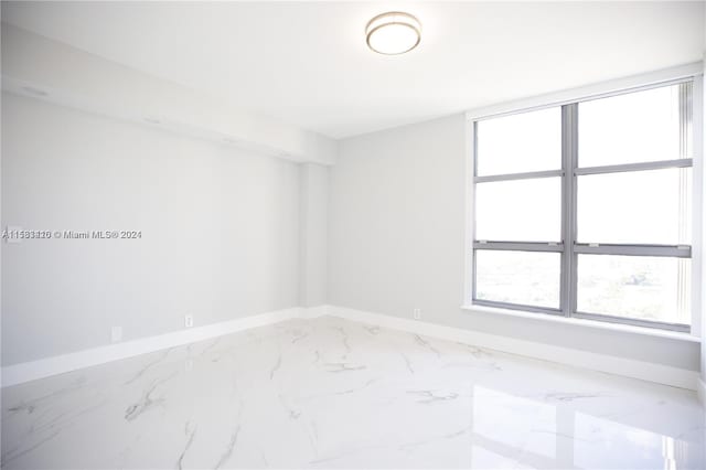 unfurnished room with tile flooring