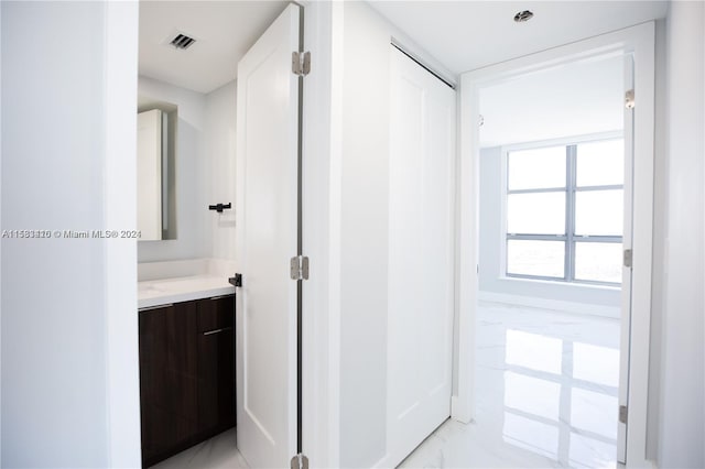 bathroom with tile flooring and vanity