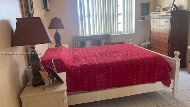 bedroom with light tile patterned floors