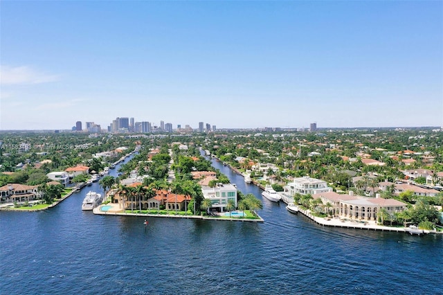 birds eye view of property with a water view and a city view