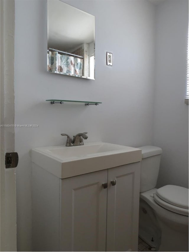 bathroom featuring vanity and toilet