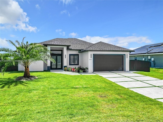 view of front of property featuring solar panels, a garage, and a front yard