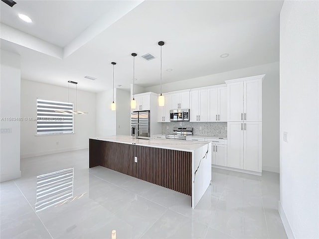 kitchen featuring a kitchen island with sink, white cabinets, decorative light fixtures, stainless steel appliances, and light tile floors