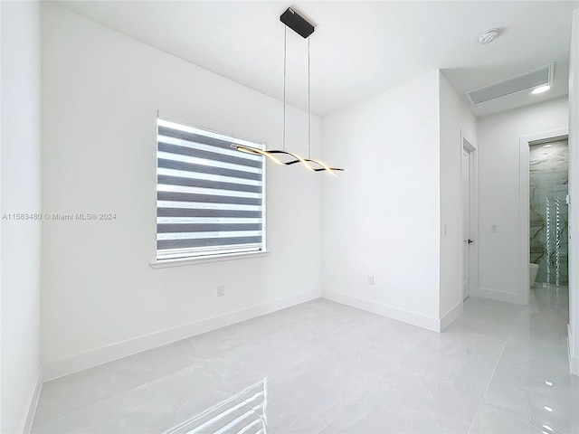 spare room featuring light tile floors