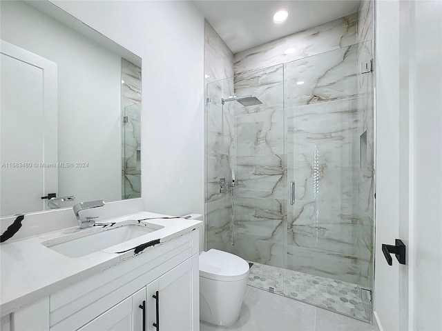 bathroom featuring walk in shower, vanity, tile floors, and toilet