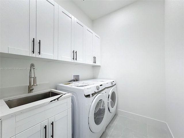 laundry room featuring light tile floors, cabinets, sink, hookup for a washing machine, and separate washer and dryer