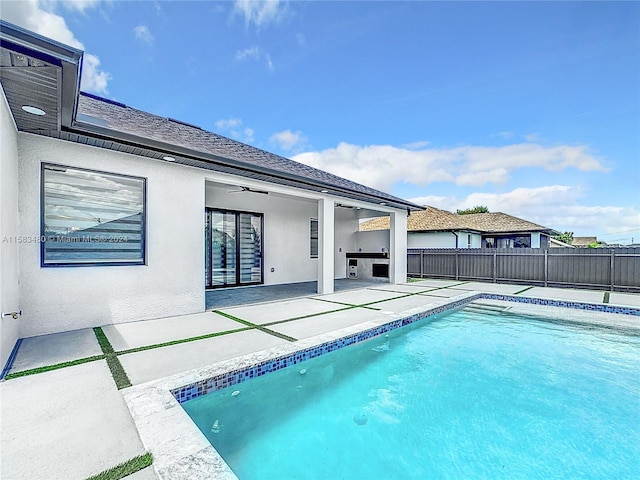 view of swimming pool with a patio area and ceiling fan