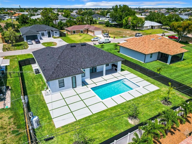 view of pool featuring a lawn and a patio area