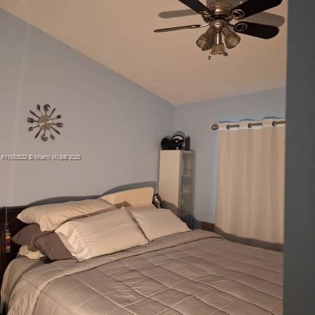 bedroom with vaulted ceiling and ceiling fan